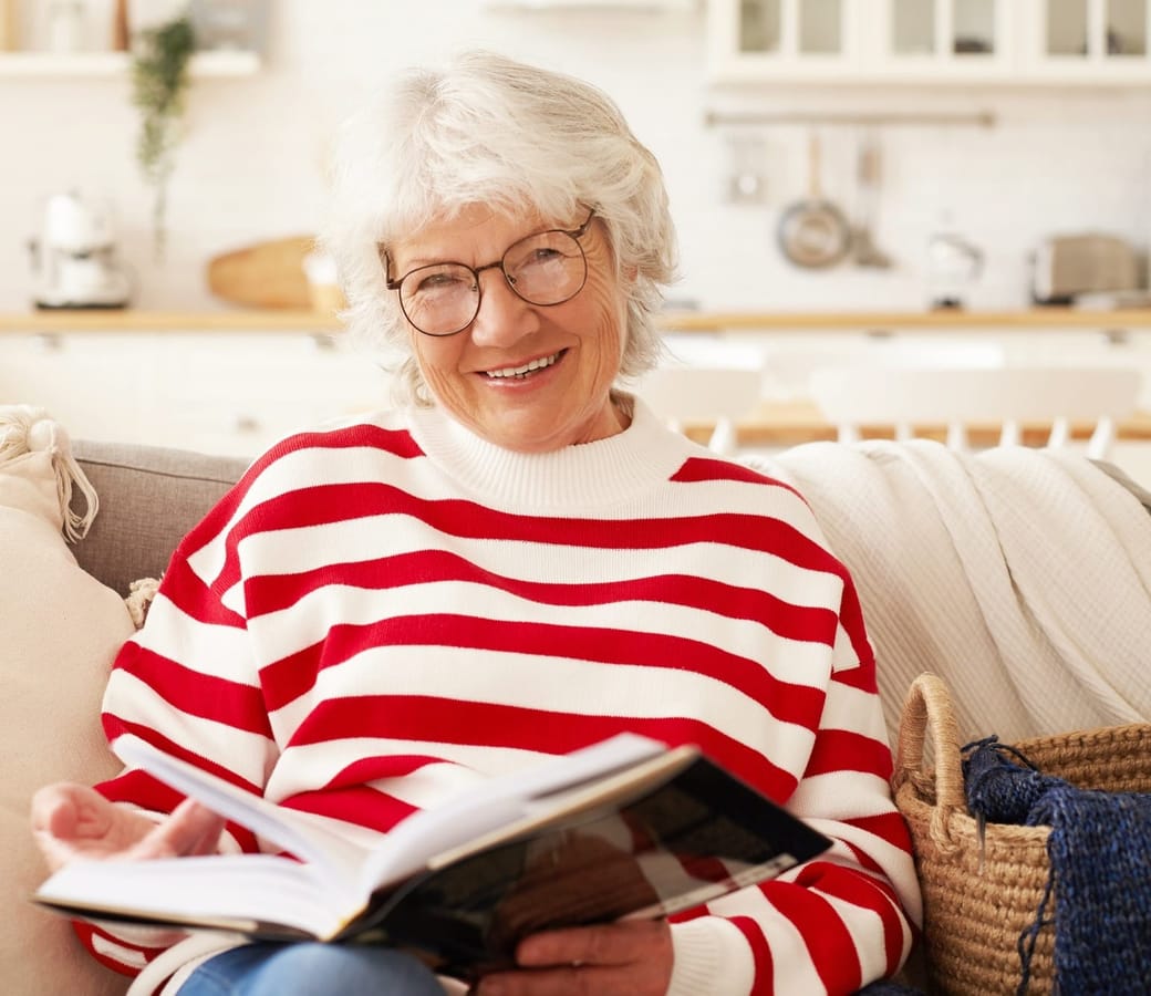 leisure-self-education-hobby-retirement-concept-picture-good-looking-mature-senior-female-striped-sweater-stylish-eyewear-enjoying-reading-living-room-smiling-joyfully.jpg